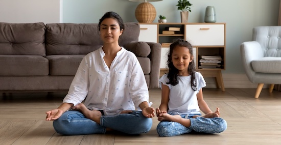 Photo of woman and child meditating