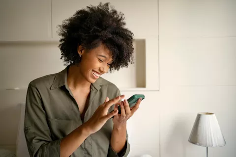 Adult smiling at the phone.