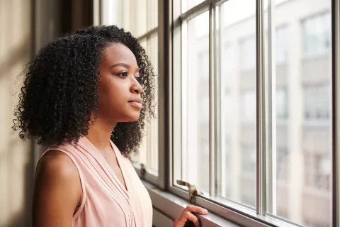 A woman staring outside the window