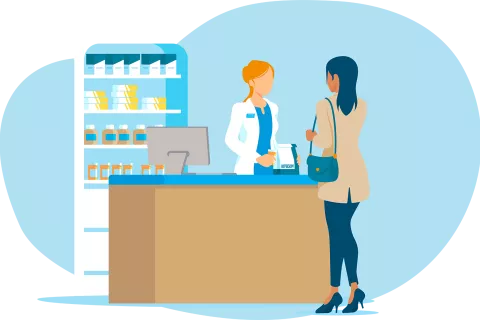 Adult at the pharmacy, taking a prescription from the pharmacist.