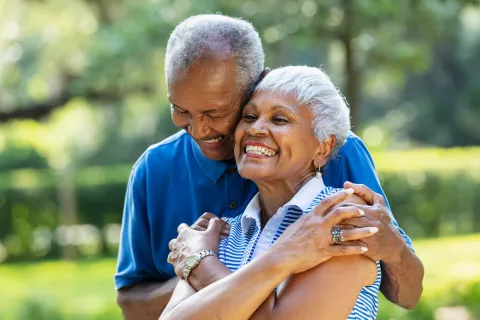 A senior couple happily embracing each other.