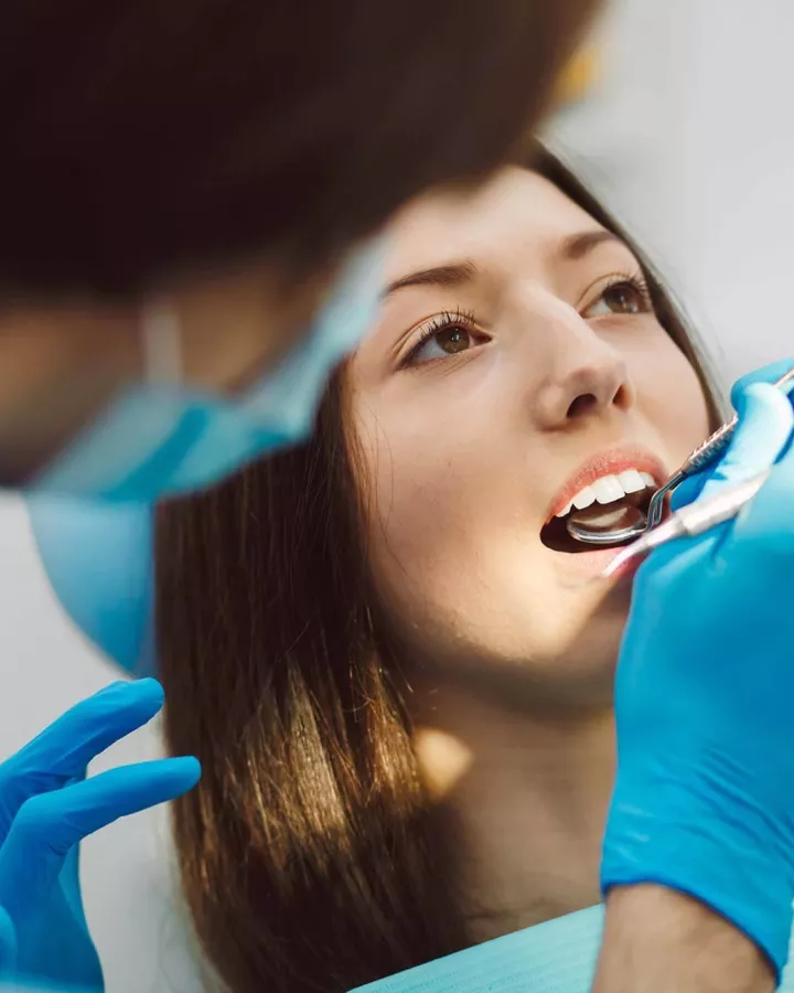 Dentist examining an adult's mouth.