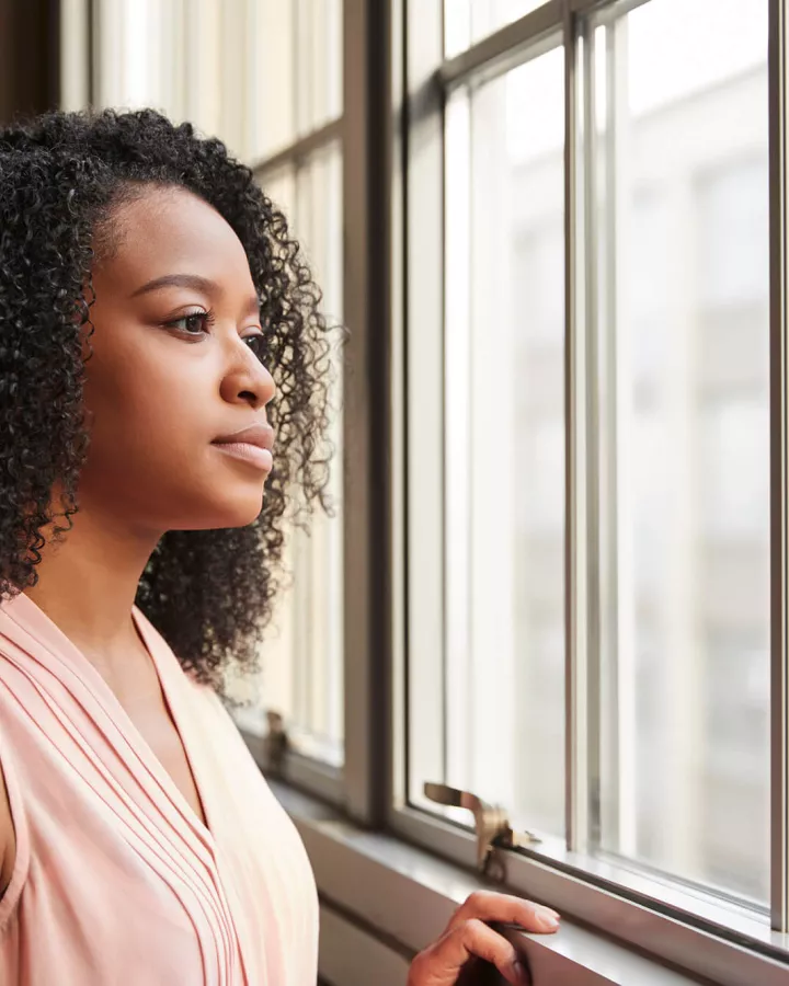 A woman staring outside the window